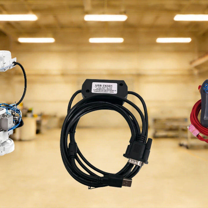 A white ABB industrial robot shown with a black USR-TK501 communication cable and a FlexPendant teach pendant with a red cable, set against a blurred factory workspace background.