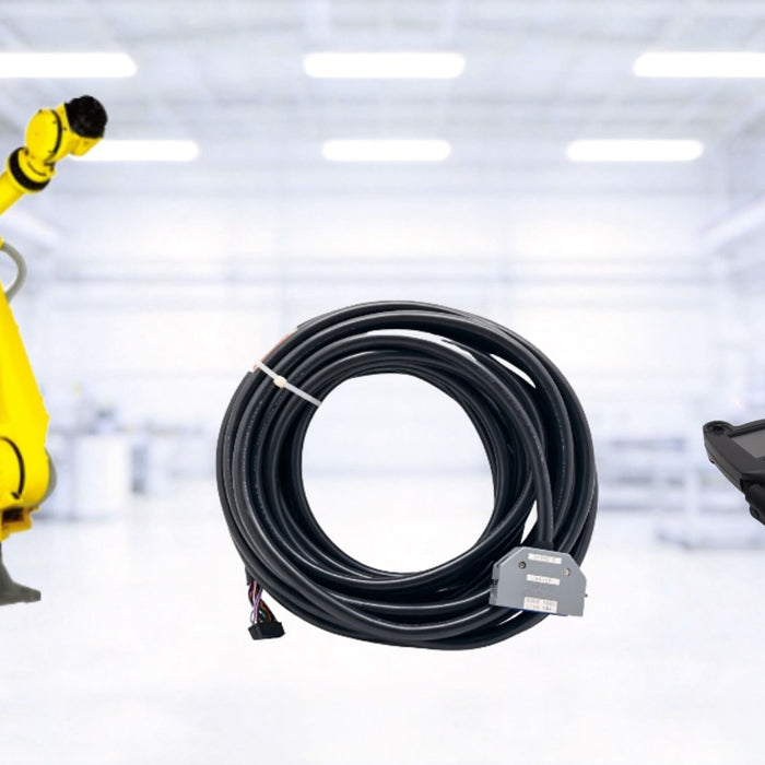 A classic yellow FANUC industrial robot arm shown with a coiled black communication cable and a FANUC iPendant, set against a bright, blurred automated factory background.
